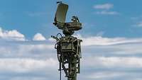 Die Antenne des Artilleriebeobachtungsradars ABRA vor einem blau-weißen Himmel