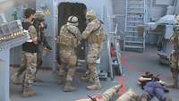 Zwei Soldaten des Boardingteams überprüfen Räume nach möglicher Schmuggelware