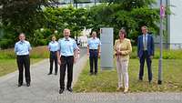 Gruppenfoto mit mehreren Soldatinnen und Soldaten, sowie einer Zivilistin und einem Zivilisten