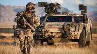 Afghanistan: An ISR soldier scans for booby traps in front of his Fennek reconnaissance vehicle.