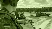 A platoon leader observing the Dachs armoured engineer vehicle at work.