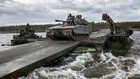 Engineers ferry a Dutch armoured infantry combat vehicle across a large river in Norway.