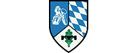 Im silbern-blau geteilten Wappen rechts ein Pionier, links ein Edelweiß, darüber eine Pionierbrücke.