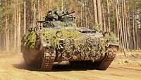 A Marder infantry fighting vehicle drives through the terrain