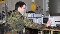 A soldier working on an oscilloscope.