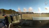 Smoke grenades being fired from the roof of a truck