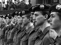 Black-and-white shot of the soldiers who stood up