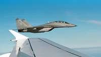 A Mig 29 fighter aircraft can be seen from the window of a Bundeswehr aircraft