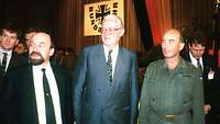 Schönbohm, Stoltenberg and Eppelmann stand side by side, with the Bundeswehr logo in the background