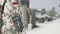 NATO OTAN badge on the uniform of a soldier of the ISAF troops in Afghanistan