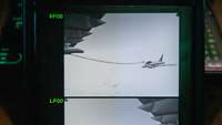 Auf einem Bildschirm sieht man ein Livebild von außerhalb des A400M bei der Betankung.