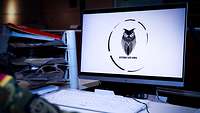 Das Wappen der Extricate Owl 2021 auf einem Bildschirm