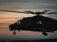 Silhouette of a helicopter against the evening sky