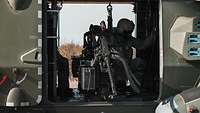 A machine gun mounted in the side door of a helicopter