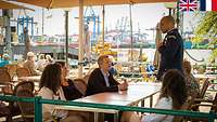 People are having coffee while enjoying the views of Hamburg harbour