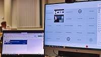 Zwei Computerbildschirme zeigen die Teilnehmer des Workshops und die Übersicht über das Programm