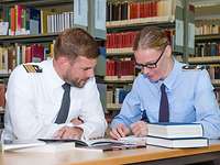 Two soldiers study together