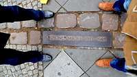 Ein Schild mit der Aufschrift Berliner Mauer ist zu sehen