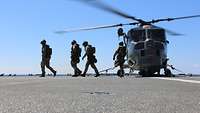 Vier Soldaten des Bordeinsatzteams bei dem Ausstieg aus dem Helikopter 