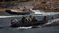 Training: Two inflatable boats are cruising on the water; the outboard engines are churning it up.