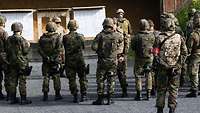 Soldiers stand on a shooting range.