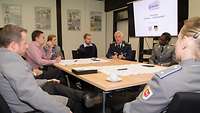 Soldiers sit around a table