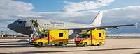 Zwei Fahrzeuge des Rettungsdienstes stehen vor einem medizinischen Flugzeug der Luftwaffe