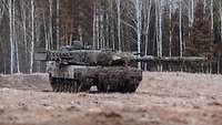 Ein Leopard Kampfpanzer sichert das Vorgelände auf dem Marsch