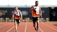 Zwei deutsche Sportler rennen auf der zweihundert Meter Bahn