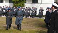 Zwei Soldaten laufen entlang der Reihe Soldaten