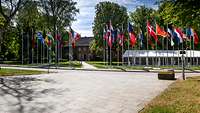 Flags of the countries participating in the CoC in front of a building of the Bundeswehr Command and Staff College