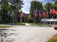 Flags of the countries participating in the CoC in front of a building of the Bundeswehr Command and Staff College