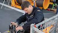 A man is checking the functions of a measuring buoy