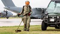 A member of the terrain management team mows the lawn at Wunstorf airfield.