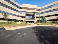 Exterior view of a building with a parking lot in front