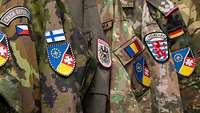 Multinational coats of arms on various uniforms.