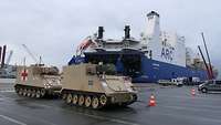 Vehicles drive out of a large ferry