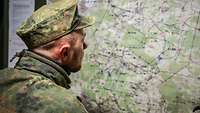 A soldier looks at a map