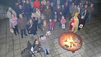 Gruppenbild mit dem Nikolaus und einer an einer Feuerstelle.