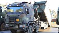 Ein Militär-Lkw lädt einen Container ab.