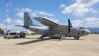 A C-27J aircraft can be seen standing on a runway.