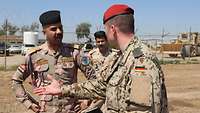 Ein deutscher Soldat im Austausch mit einem irakischen Soldaten.