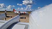 Zwei Flugzeuge stehen auf einem Flugfeld