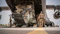 Soldaten verladen einen Mehrzweckhubschrauber NH-90 in ein US-Transportflugzeug C17.