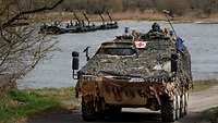 A medical vehicle moves along the banks of the Elbe river.