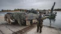 An IFV drives ashore off a ferry.