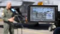 General Gerhartz is filmed by the press. Here through a display of a camera.