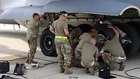 Technicians changing an aircraft tyre.
