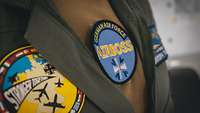 Patches on the uniform of an airboss during Air Defender 23