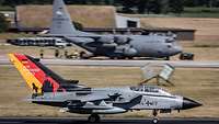 A specially painted Tornado together with an American C-130 Hercules during takeoff.